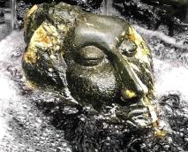 Stone face in water, from fountain at Chanticleer