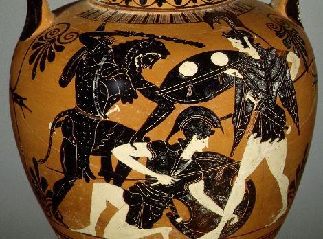 Herakles (left) battles Hippolyte (center). Herakles grabs Hippolyte by her right arm with his left hand, raising his club in his right. Hippolyte has fallen to her right knee, and supports herself with the shield on her left arm. A wrapped object at her waist may represent the belt Herakles was sent to retrieve. A second Amazon (left) raises her shield attempting to engage Herakles.