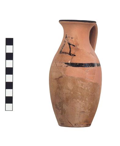 A red clay jug with much of its glaze missing except for a small black stripe on the shoulder and at the rim, and a large black marking on the top third of the vessel. 