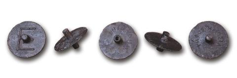 five metal discs, each with central protrusions and wrapped with a line of Greek lettering