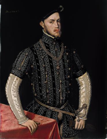 Young bearded man in royal dress standing with one hand on a table