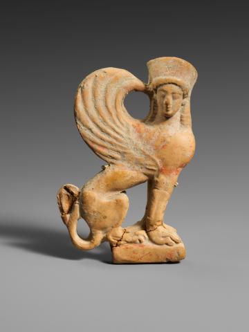 Terracotta relief of a sphinx in profile facing right. Her head is turned to face the viewer. She wears a hat or headdress, her hair hanging loose to her shoulders. Her wings are swept back with the tips curving up and over to touch her head.