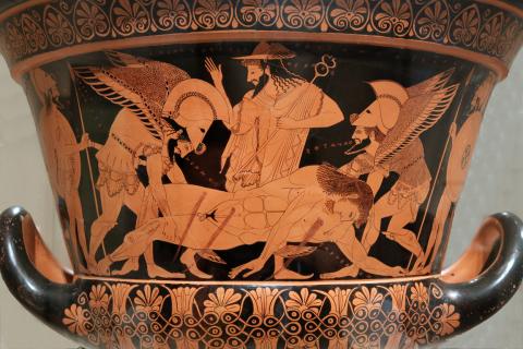 Hypnos (foreground center left) and Thanatos (foreground center right) lift the body of Sarpedon (foreground center) overseen by Hermes (background center). Sarpedon bleeds from three wounds-one to the left pectoral, one to the lower right abdomen, and one to the right thigh. Hermes wears his winged helmet and carries his caduceus in his left hand. His right hand is raised, perhaps in direction. The scene is flanked by Laodamas and Hippolytos. All the characters are named by inscriptions.