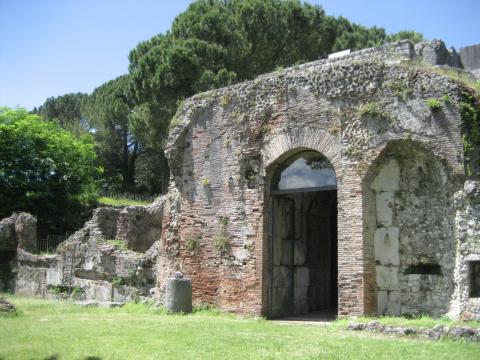 Ruins of a large stone structure with high arched entrance