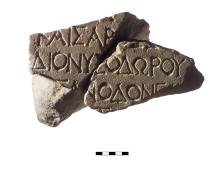 Two triangular marble fragments with lines of Greek lettering