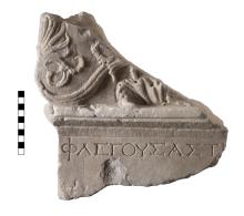 A triangular fragment of Pentelic marble, the top half of which is decorated in an Acanthus motif and the bottom half of which has a fragment of a line of Greek Lettering