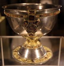 a silver chalice with gold trim