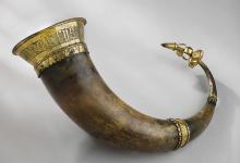 a medieval drinking horn with brass fittings