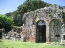 Ruins of a large stone structure with high arched entrance