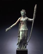 Bronze statuette of Ceres holding a large torch in her left hand and extending a sheaf of wheat toward the viewer with her right