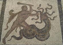 Heracles (left) grasps the Hydra (right) by one of its many necks while it coils its tail around his left leg. Hercules raises his club in his right hand, preparing to strike.