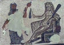 Hercules (left) is dressed in women's clothes. He holds a distaff with wool in his left hand and what appears to be a drop spindle in his right (mosaic is damaged). Omphale is seated (right) nude except for Hercules' traditional lion skin. Hercules' club rests in the crook of her left arm.