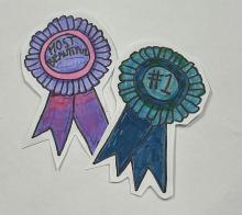 A collage composed of two cut-out drawings of award ribbons. The left-hand ribbon is shaded in purple tones and bears the legend "most beautiful," the right hand ribbon is shaded in blue-green tones and says "#1."