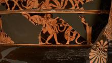 Heracles (center) stands in profile facing right. He wears his lion skin on his head and draped over his left arm, which is raised protectively  across his body. He holds his club in his left hand; his quiver sits on his left hip. His right arm is raised, but vase is damaged and the hand is missing. Ladon is depicted as a snake or snakes wrapped around a tree. Three heads are visible but the damage cuts off the top of the tree making it unclear whether it is one multi-headed monster or several.